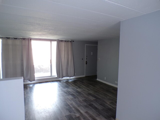 12548 Fairview Ave Unit 2B, Blue Island, IL 60406 - empty room featuring dark wood-style flooring and baseboards