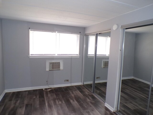 12548 Fairview Ave Unit 2B, Blue Island, IL 60406 - unfurnished bedroom with dark wood-style floors, baseboards, and a wall mounted air conditioner