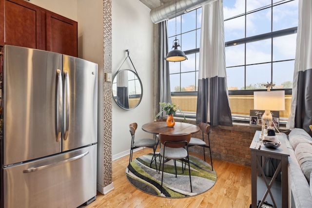 3963 W Belmont Ave Unit 137, Chicago, IL 60618 - kitchen featuring freestanding refrigerator, light wood-type flooring, and baseboards