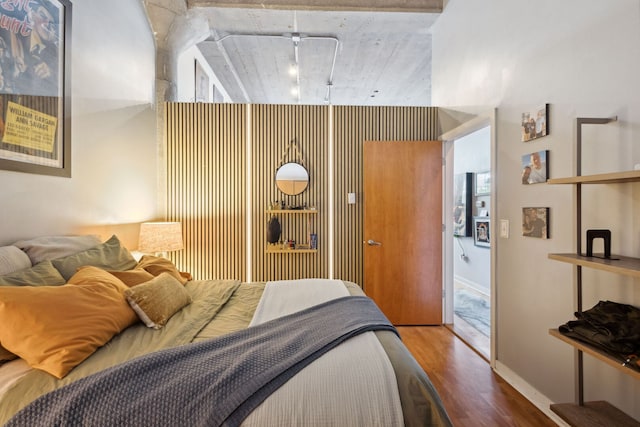 3963 W Belmont Ave Unit 137, Chicago, IL 60618 - bedroom featuring wood finished floors, track lighting, and baseboards