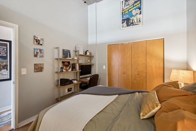 3963 W Belmont Ave Unit 137, Chicago, IL 60618 - bedroom featuring a closet, wood finished floors, and baseboards