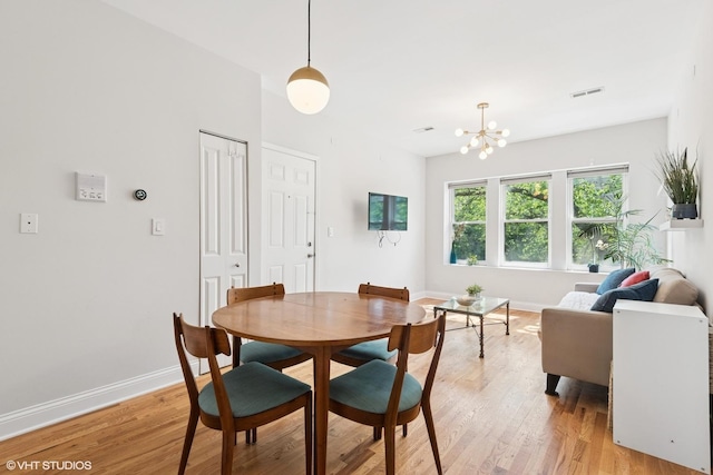 3414 N Racine Ave Unit 2, Chicago, IL 60657 - dining area featuring light wood finished floors and a chandelier