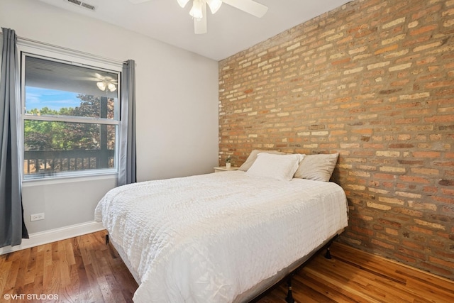3414 N Racine Ave Unit 2, Chicago, IL 60657 - bedroom featuring brick wall, hardwood / wood-style flooring, and a ceiling fan