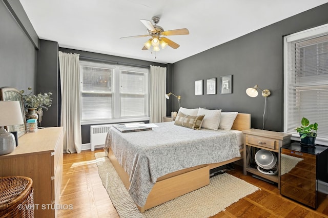 1585 Ridge Ave Unit 110, Evanston, IL 60201 - bedroom featuring light wood-style floors, radiator, and ceiling fan
