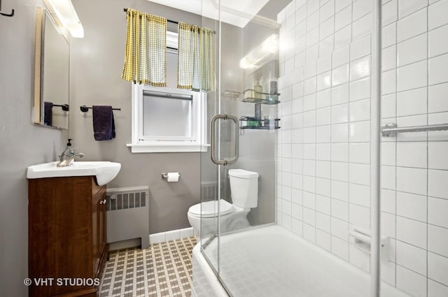 1585 Ridge Ave Unit 110, Evanston, IL 60201 - bathroom featuring radiator heating unit, a tile shower, and vanity