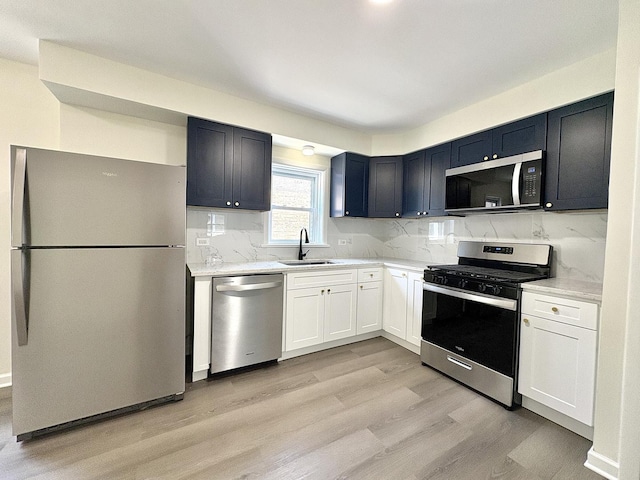 4937 S Kilpatrick Ave, Chicago, IL 60632 - kitchen with stainless steel appliances, a sink, light wood-type flooring, and tasteful backsplash