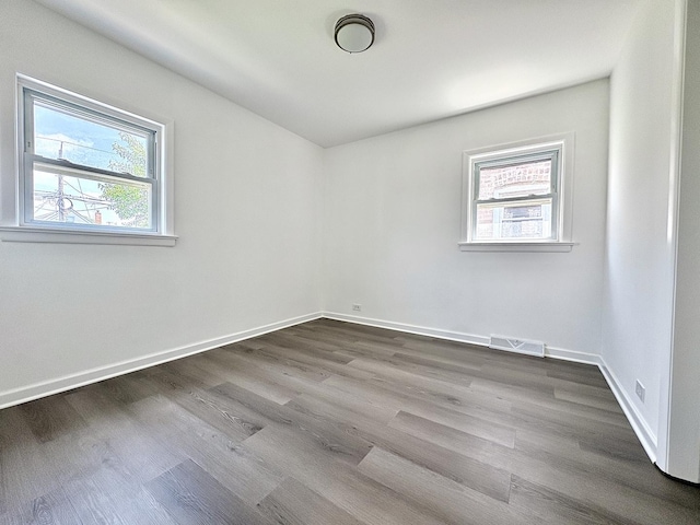 4937 S Kilpatrick Ave, Chicago, IL 60632 - unfurnished room with healthy amount of natural light, dark wood finished floors, and baseboards