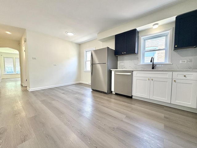 4937 S Kilpatrick Ave, Chicago, IL 60632 - kitchen featuring appliances with stainless steel finishes, a sink, light wood finished floors, light countertops, and baseboards