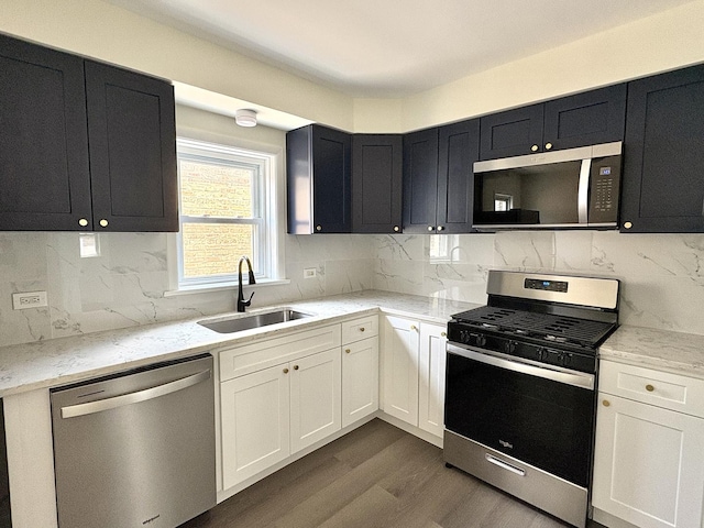 4937 S Kilpatrick Ave, Chicago, IL 60632 - kitchen featuring stainless steel appliances, a sink, dark wood-style floors, and dark cabinets