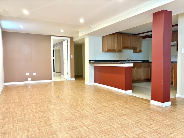 4937 S Kilpatrick Ave, Chicago, IL 60632 - kitchen with baseboards, recessed lighting, open floor plan, dark countertops, and a sink