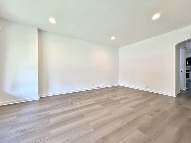 4937 S Kilpatrick Ave, Chicago, IL 60632 - unfurnished room featuring arched walkways, wood finished floors, recessed lighting, and baseboards