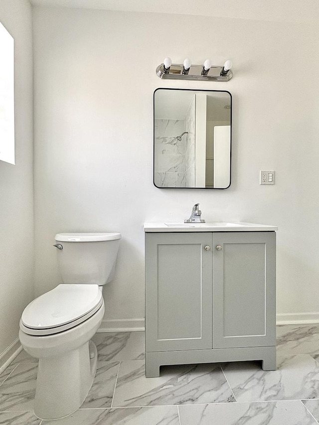4937 S Kilpatrick Ave, Chicago, IL 60632 - bathroom featuring baseboards, marble look tile flooring, and vanity
