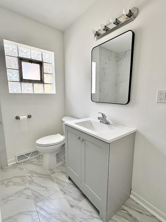 4937 S Kilpatrick Ave, Chicago, IL 60632 - bathroom featuring marble finish floors, vanity, toilet, and baseboards