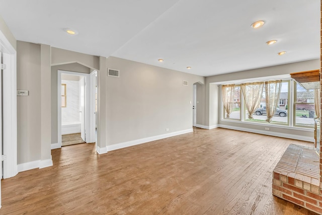 10026 Spaulding Ave, Evergreen Park, IL 60805 - unfurnished living room featuring wood finished floors, baseboards, recessed lighting, and arched walkways