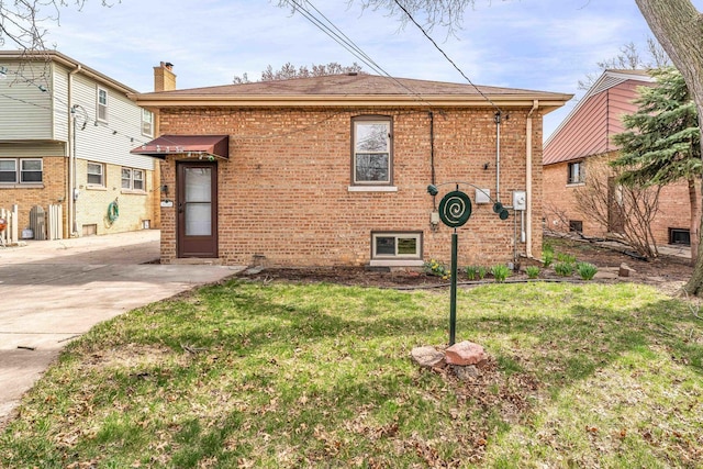 10026 Spaulding Ave, Evergreen Park, IL 60805 - view of property exterior featuring brick siding, a yard, and a chimney