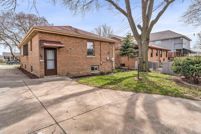 10026 Spaulding Ave, Evergreen Park, IL 60805 - rear view of house with brick siding, concrete driveway, and roof with shingles