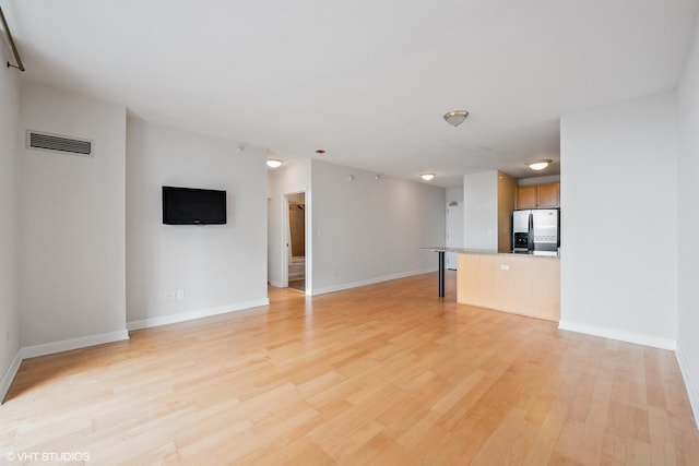 1101 S State St Unit 1805, Chicago, IL 60605 - unfurnished living room with baseboards and light wood-style floors