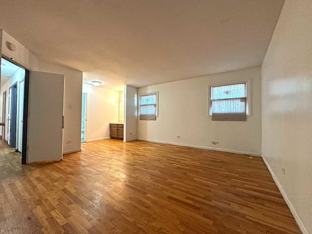 21729 Gailine Ave, Sauk Village, IL 60411 - spare room featuring wood finished floors, plenty of natural light, and a smoke detector
