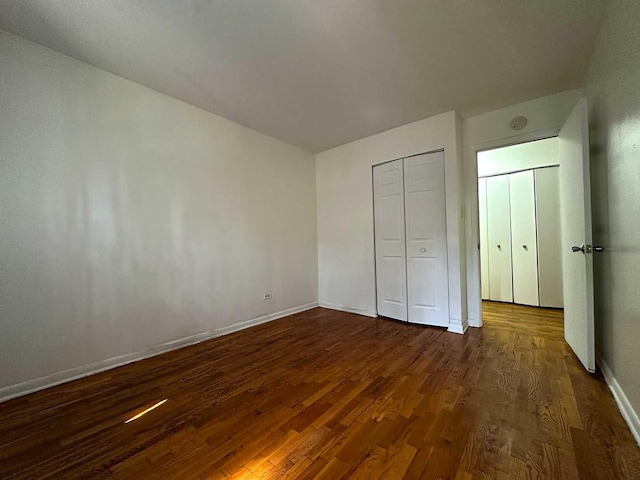 21729 Gailine Ave, Sauk Village, IL 60411 - unfurnished bedroom with dark wood finished floors and a closet