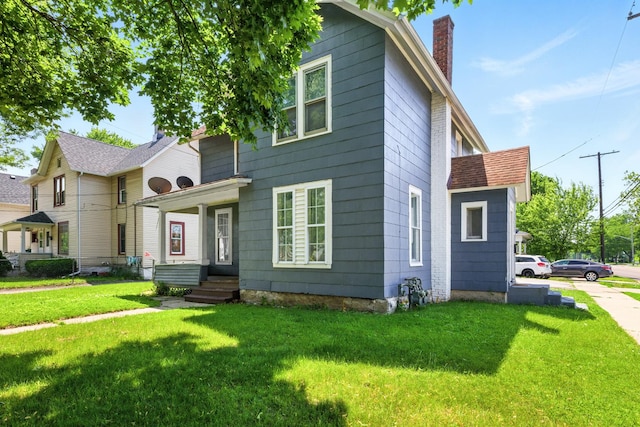 650 Pennsylvania Ave, Aurora, IL 60506 - view of front of house featuring a chimney and a front lawn
