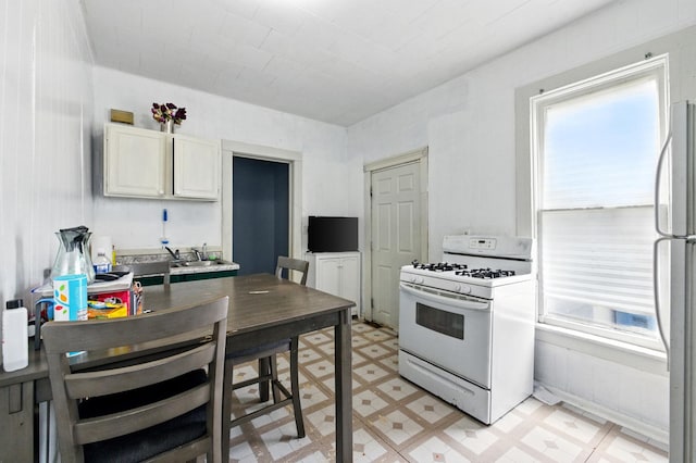 650 Pennsylvania Ave, Aurora, IL 60506 - kitchen with white appliances, healthy amount of natural light, light flooring, and white cabinetry