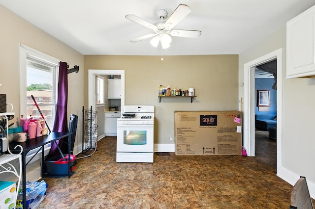 650 Pennsylvania Ave, Aurora, IL 60506 - kitchen with white gas stove, ceiling fan, white cabinetry, and baseboards