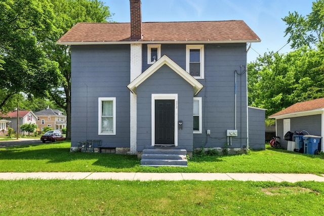 650 Pennsylvania Ave, Aurora, IL 60506 - view of front of home with a chimney and a front yard