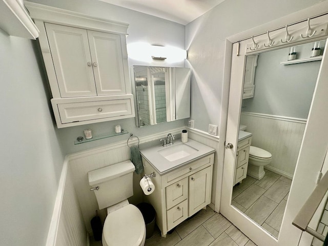 1110 Hampton Hbr Unit 1110, Schaumburg, IL 60193 - bathroom with toilet, a wainscoted wall, vanity, and marble finish floors