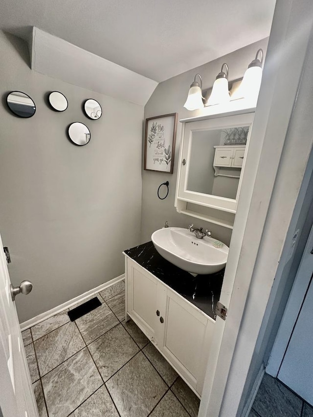 1110 Hampton Hbr Unit 1110, Schaumburg, IL 60193 - bathroom with vaulted ceiling, vanity, baseboards, and tile patterned flooring