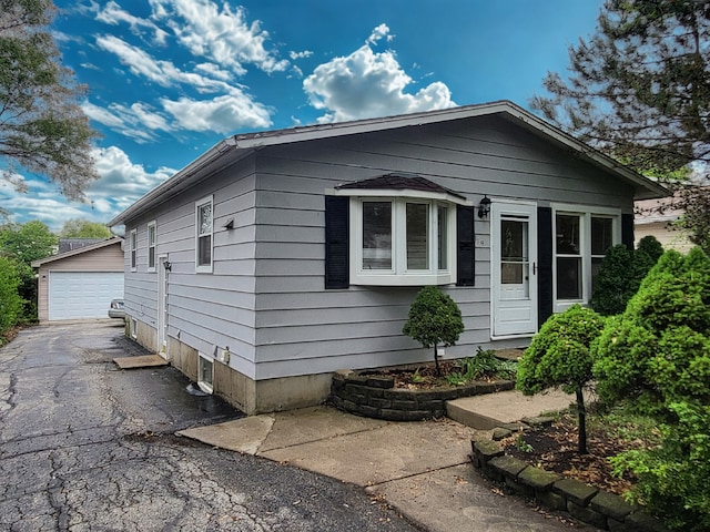 319 Hillandale St, Round Lake, IL 60073 - view of side of home featuring a garage and an outdoor structure