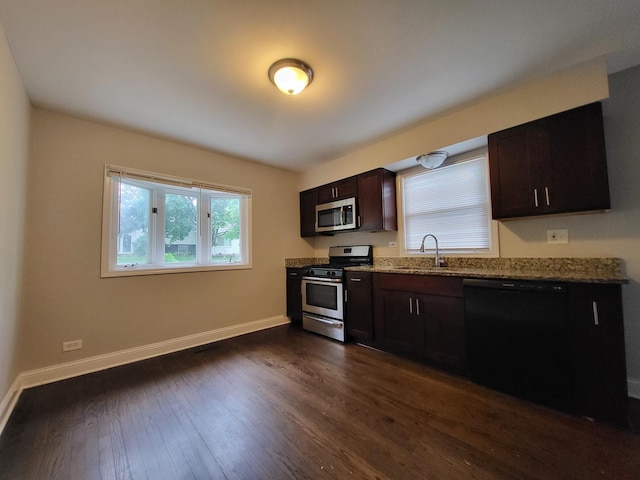 319 Hillandale St, Round Lake, IL 60073 - kitchen with appliances with stainless steel finishes, dark wood-style flooring, light stone counters, and dark brown cabinetry