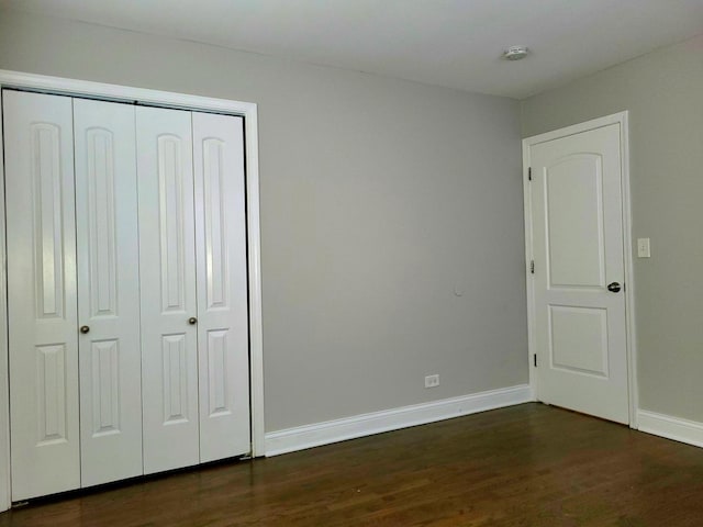 319 Hillandale St, Round Lake, IL 60073 - unfurnished bedroom featuring dark wood-style floors and a closet