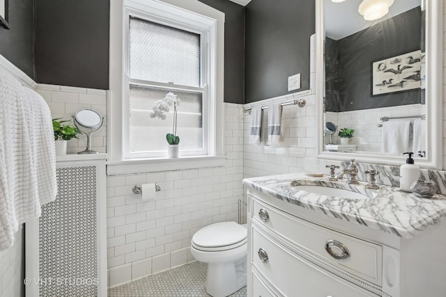 542 Michigan Ave Unit 1, Evanston, IL 60202 - bathroom with tile walls, plenty of natural light, vanity, tile patterned flooring, and a wainscoted wall