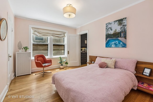 542 Michigan Ave Unit 1, Evanston, IL 60202 - bedroom with radiator heating unit, crown molding, and wood finished floors