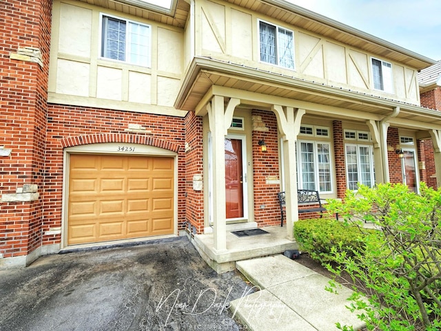 34251 N Homestead Rd, Gurnee, IL 60031 - doorway to property with brick siding, an attached garage, and stucco siding