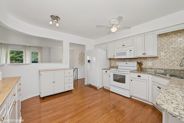 505 Crest Dr, Cary, IL 60013 - kitchen with white appliances, light wood-style flooring, backsplash, and ceiling fan