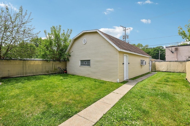 17852 Walter St, Lansing, IL 60438 - view of side of property featuring a fenced backyard, a wall unit AC, a shingled roof, and an outbuilding