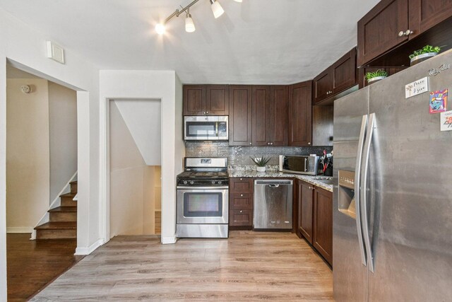 17852 Walter St, Lansing, IL 60438 - kitchen with stainless steel appliances, light wood-style floors, tasteful backsplash, dark brown cabinets, and rail lighting