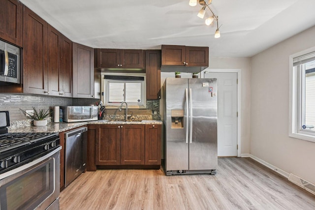 17852 Walter St, Lansing, IL 60438 - kitchen featuring stainless steel appliances, decorative backsplash, light wood finished floors, and light stone counters