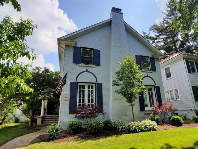 720 Ingleside Pl, Evanston, IL 60201 - view of side of home featuring a chimney, brick siding, and a lawn