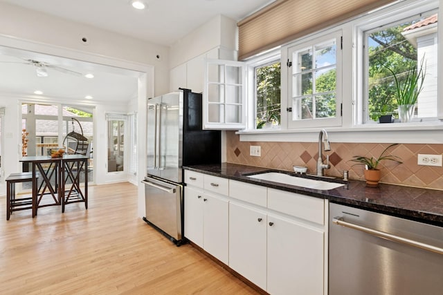 720 Ingleside Pl, Evanston, IL 60201 - kitchen with stainless steel appliances, light wood-style flooring, backsplash, white cabinets, and recessed lighting
