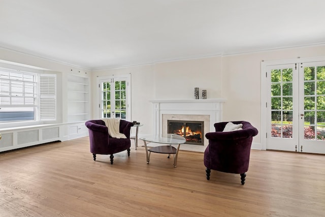 720 Ingleside Pl, Evanston, IL 60201 - living area with french doors, crown molding, a fireplace with flush hearth, and plenty of natural light