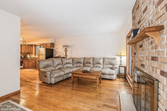 1908 Hazelwood Dr, Lindenhurst, IL 60046 - living area featuring a fireplace and light wood-style floors