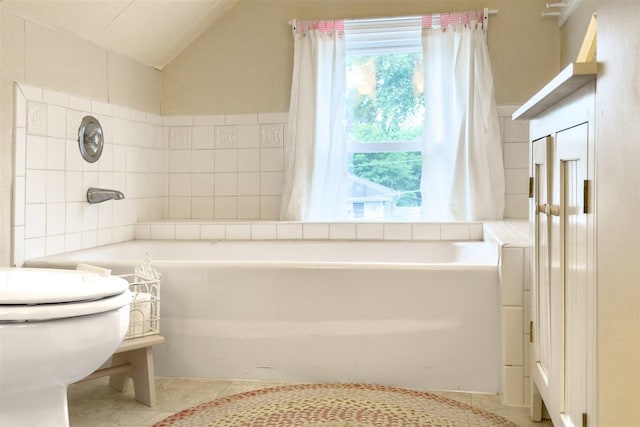 735 W Henry St, Pontiac, IL 61764 - bathroom featuring a garden tub, tile patterned flooring, and vaulted ceiling