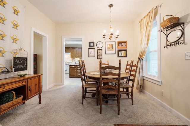 735 W Henry St, Pontiac, IL 61764 - dining area featuring a chandelier and light carpet