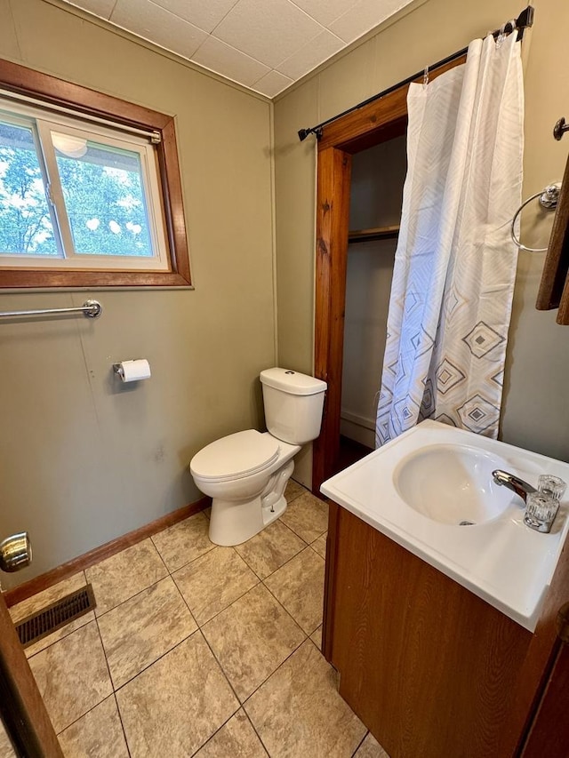 1202 E Water St, Pontiac, IL 61764 - bathroom with toilet, vanity, tile patterned flooring, and baseboards