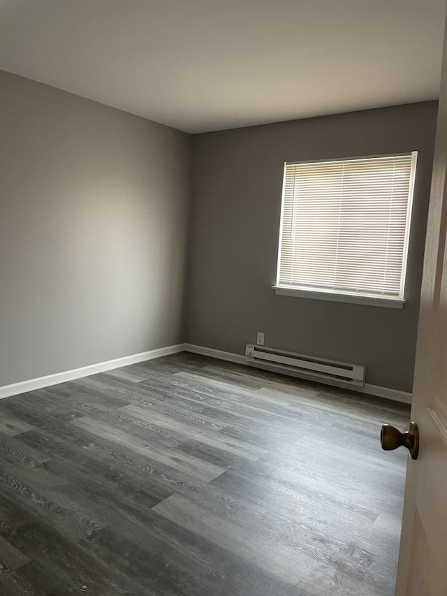 1389 Monomoy St Unit B2, Aurora, IL 60506 - empty room featuring a baseboard radiator and dark wood finished floors