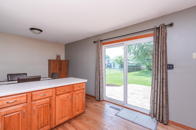350 Kathy Dr, Bourbonnais, IL 60914 - kitchen with light wood-style flooring, light countertops, and brown cabinets