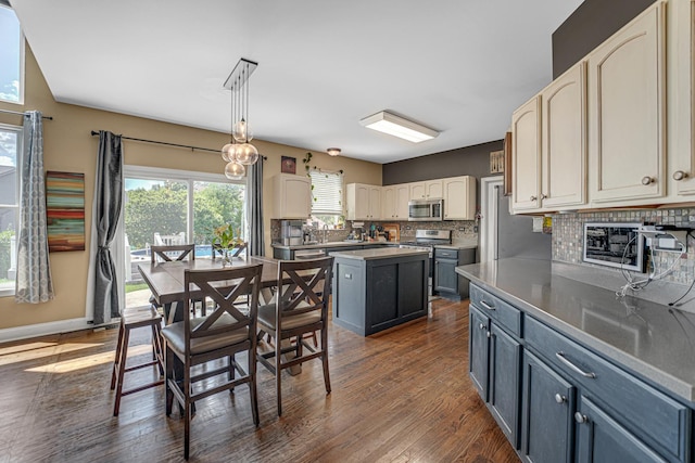 2316 Loop Rd, Algonquin, IL 60102 - kitchen featuring appliances with stainless steel finishes, dark wood finished floors, tasteful backsplash, a kitchen island, and pendant lighting