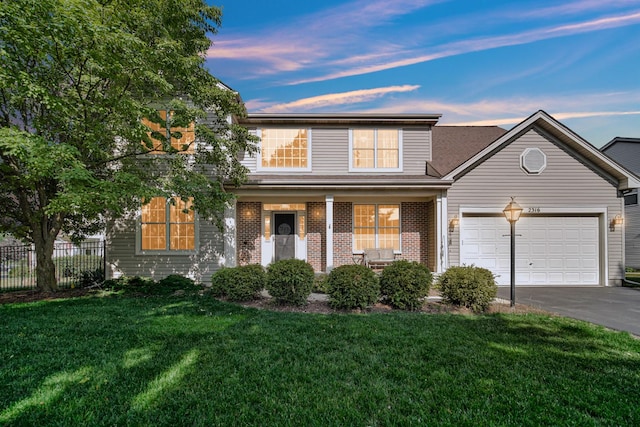2316 Loop Rd, Algonquin, IL 60102 - traditional-style home featuring driveway, an attached garage, brick siding, and a porch